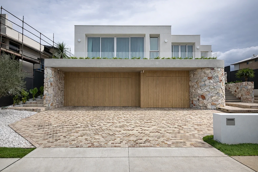 Sienna stone wall cladding on exterior pillars beside a garage by Tilemall