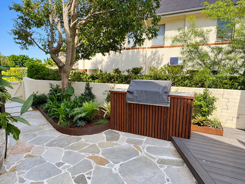 Mangolia garden crazy paving around a tree and outdoor spa by Tilemall