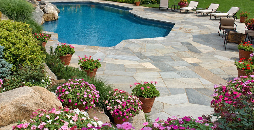 Mangolia irregular flagstone paving around a landscaped swimming pool by Tilemall