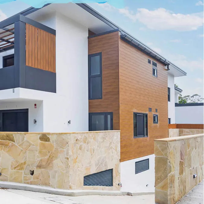 Sunrise Gold gold-toned irregular stone on a boundary wall outside a home by Tilemall