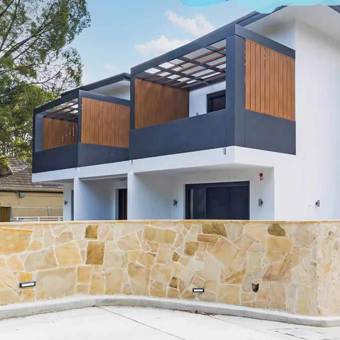 Sunrise Gold Sandstone crazy paving with warm sandstone installed on a boundary wall by Tilemall