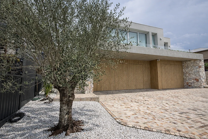 Sienna stone wall cladding on exterior pillars beside a driveway — matching walling finish reference for corners by Tilemall