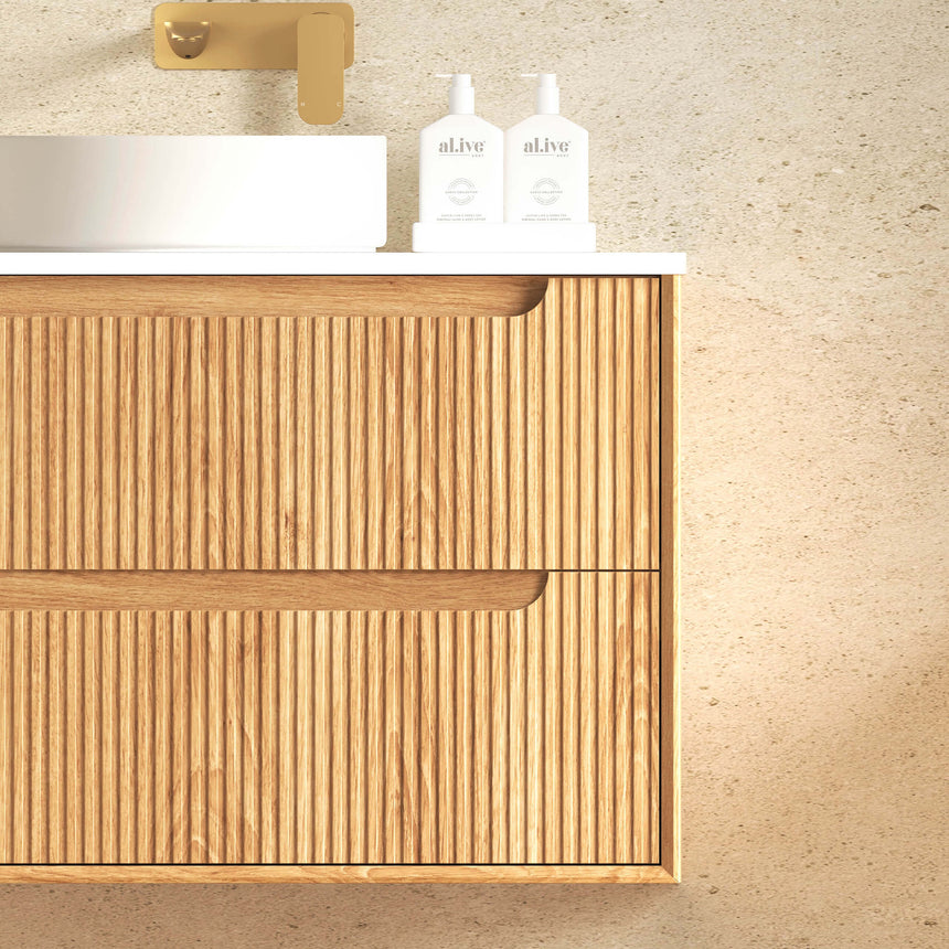 Close-up of Otti Byron Fluted vanity drawer showing vertical ribbed oak pattern and brass handle by Tilemall
