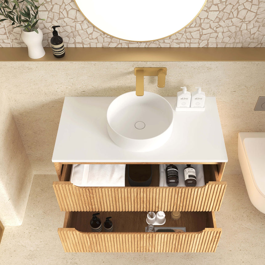 Otti Detail of Byron vanity top with white basin and brass spout above fluted drawer by Tilemall
