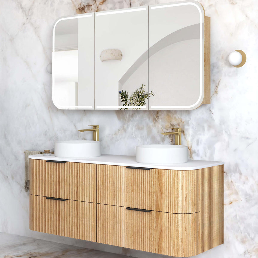 Otti Havana Fluted wall-hung vanity front view showing fluted woodland oak doors, double white vessel basins and brass taps by Tilemall