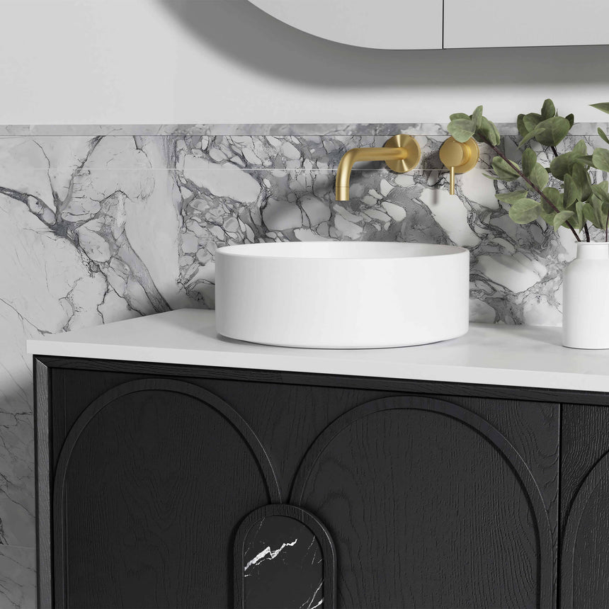 Otti Laguna MK II vanity with one white vessel basin, brass wall-mounted tap, and black oak cabinetry with arch-panel design by Tilemall