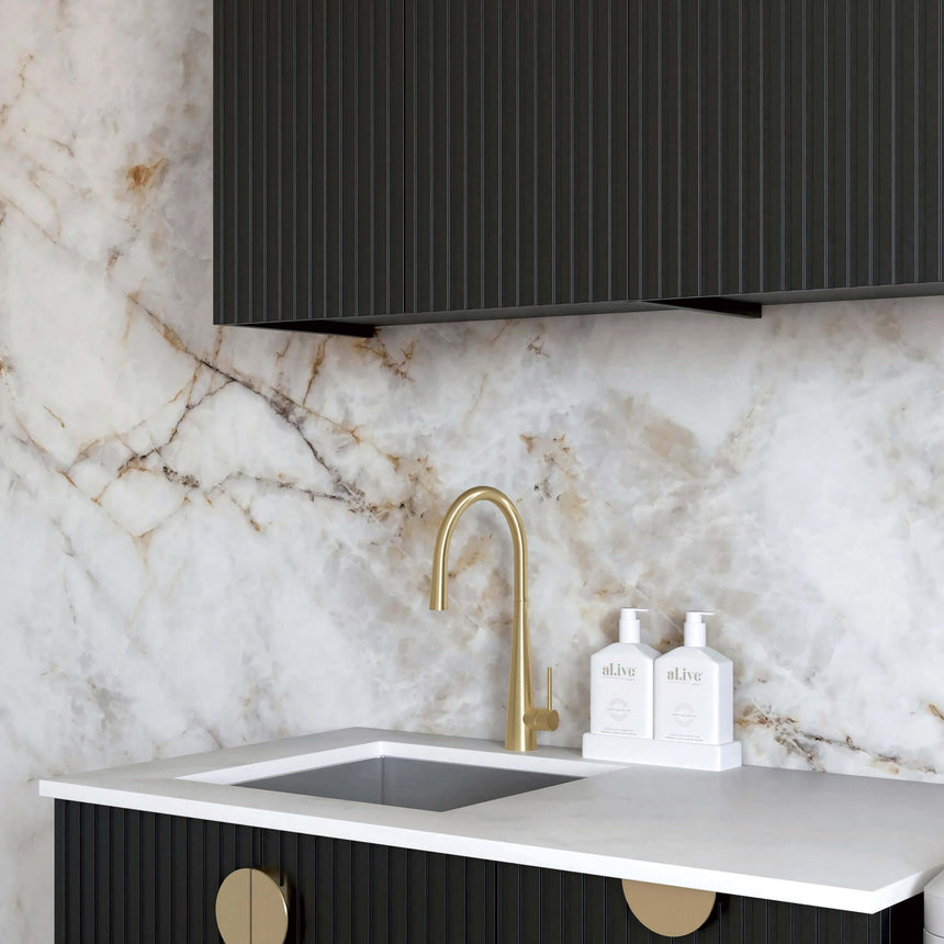 Close-up of Otti Marlo laundry sink with brass tap and white quartz stone countertop by Tilemall