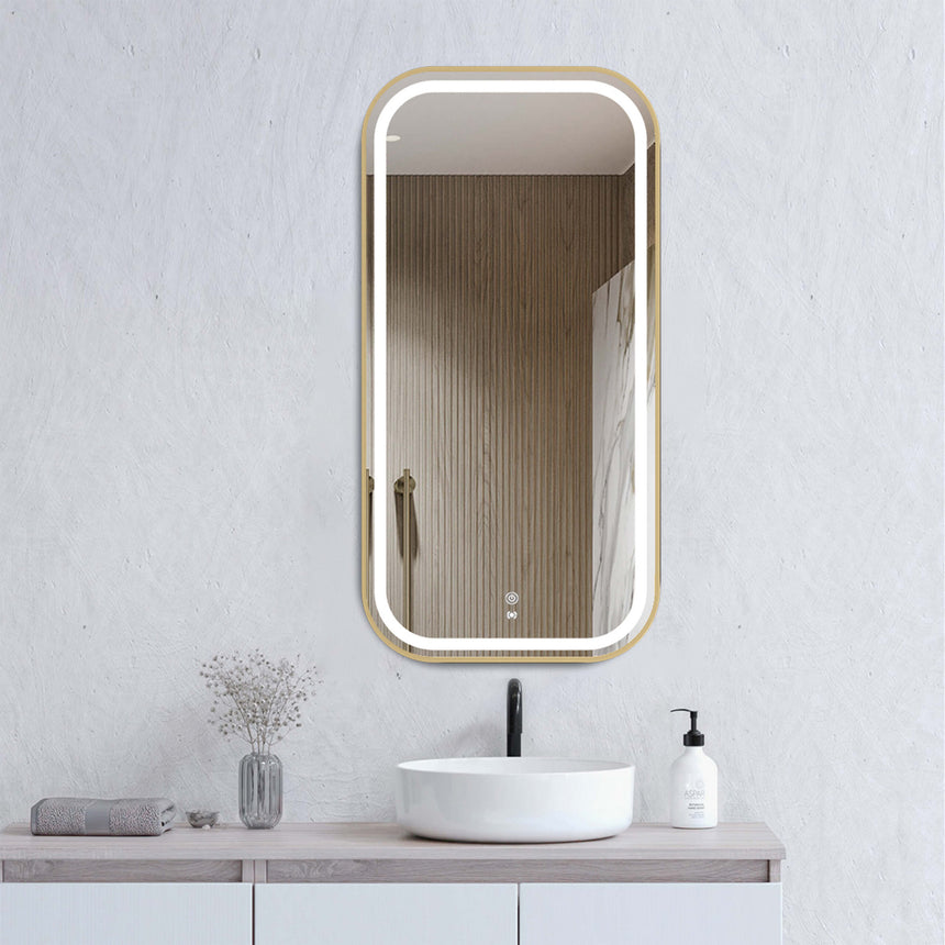Otti Newport 900x450mm LED framed mirror by Tilemall with brushed gold metal frame, installed above white basin in modern bathroom
