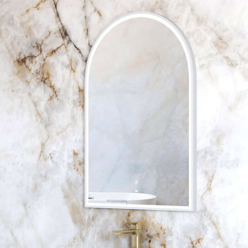 Otti Archie 900x600mm white framed LED mirror installed in bathroom interior with shelf detail by Tilemall