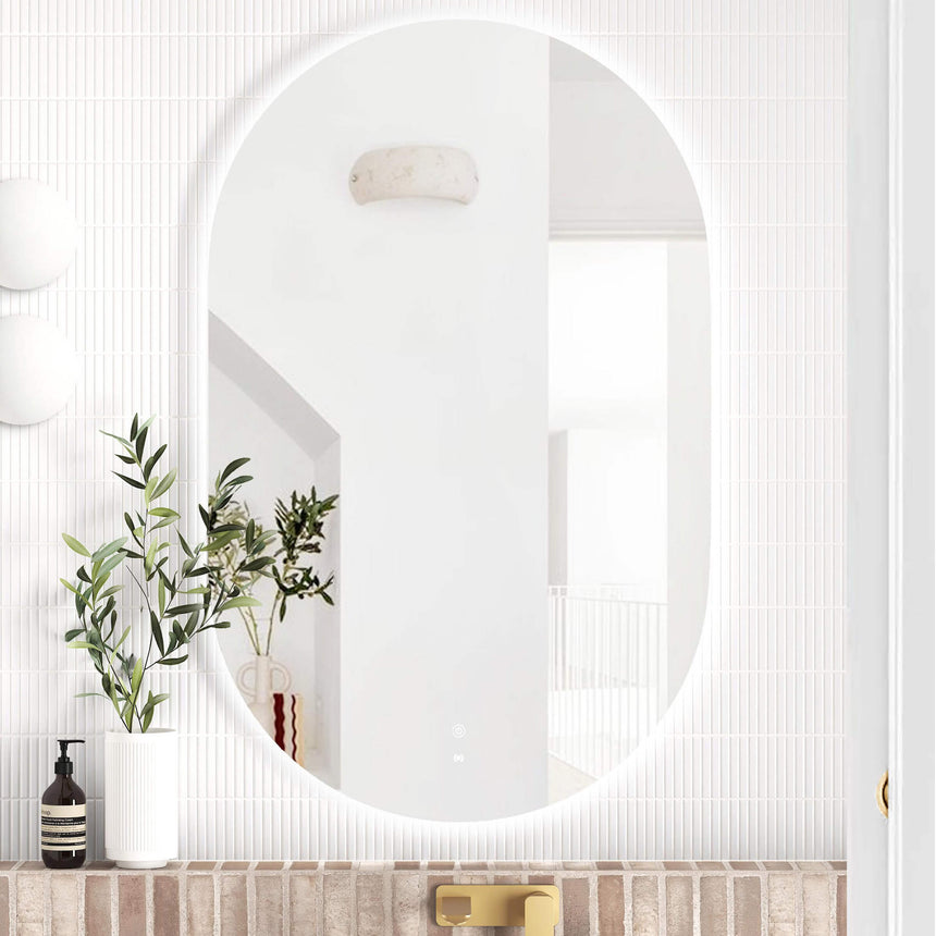 Otti Noosa oval 900x600mm LED frameless bathroom mirror by Tilemall installed above brick vanity