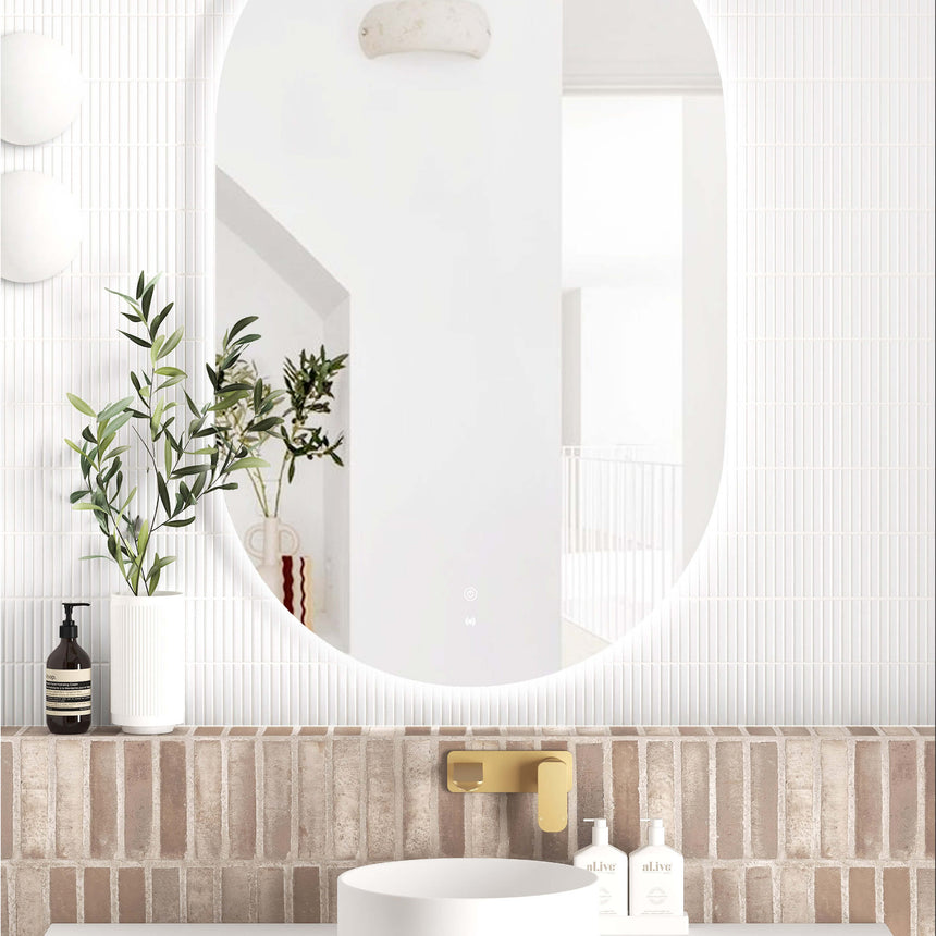 Otti Noosa 1200x750mm vertical oval LED frameless mirror by Tilemall with touch controls on brick bathroom wall