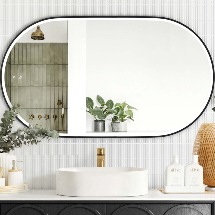 Otti Noosa 1200x750mm LED framed mirror by Tilemall with matte black metal frame installed above bathroom vanity