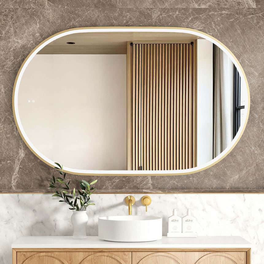Otti Noosa 1200x750mm LED framed mirror by Tilemall with brushed gold metal frame, horizontal oval shape, installed