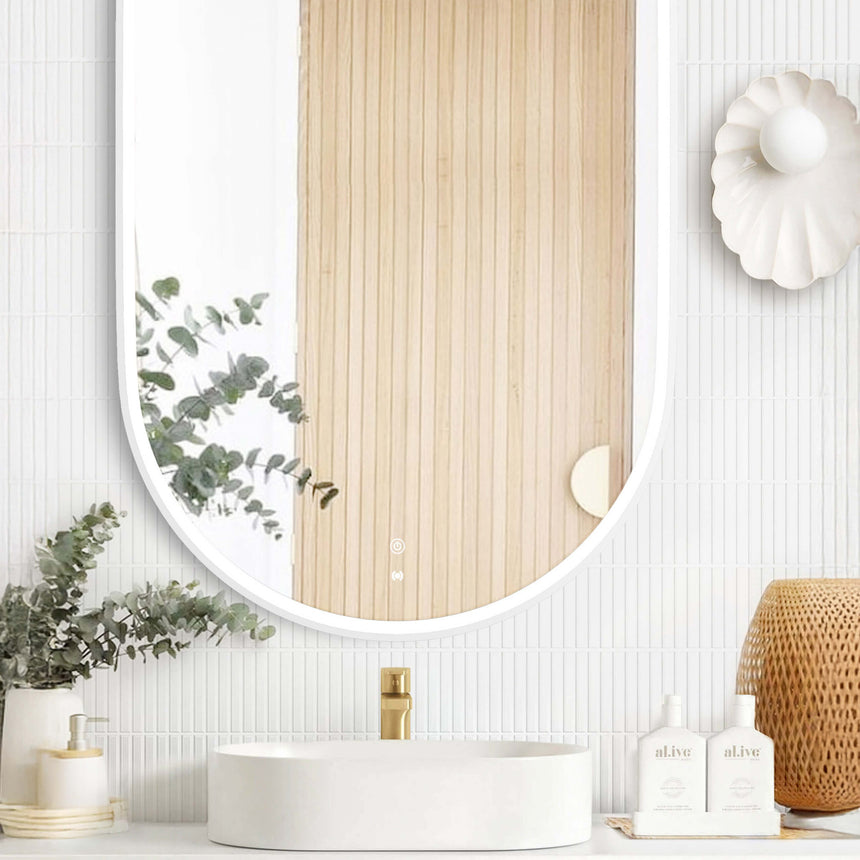 Otti Noosa 1200x750mm LED mirror installed above white vessel basin in bright bathroom interior with vertical tile wall by Tilemall