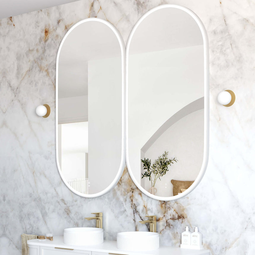 Two Otti Noosa 750x1900mm vertical LED mirrors by Tilemall with white frames side by side in bathroom interior