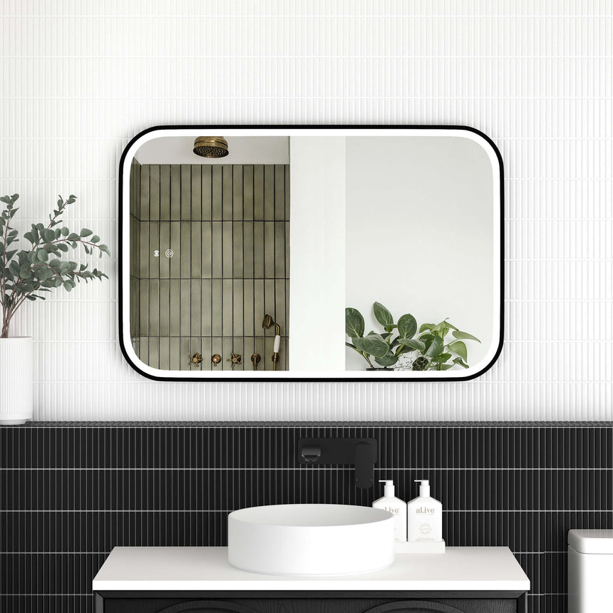 Otti Newport 900x600mm LED framed mirror by Tilemall with matte black metal frame, installed above bathroom vanity