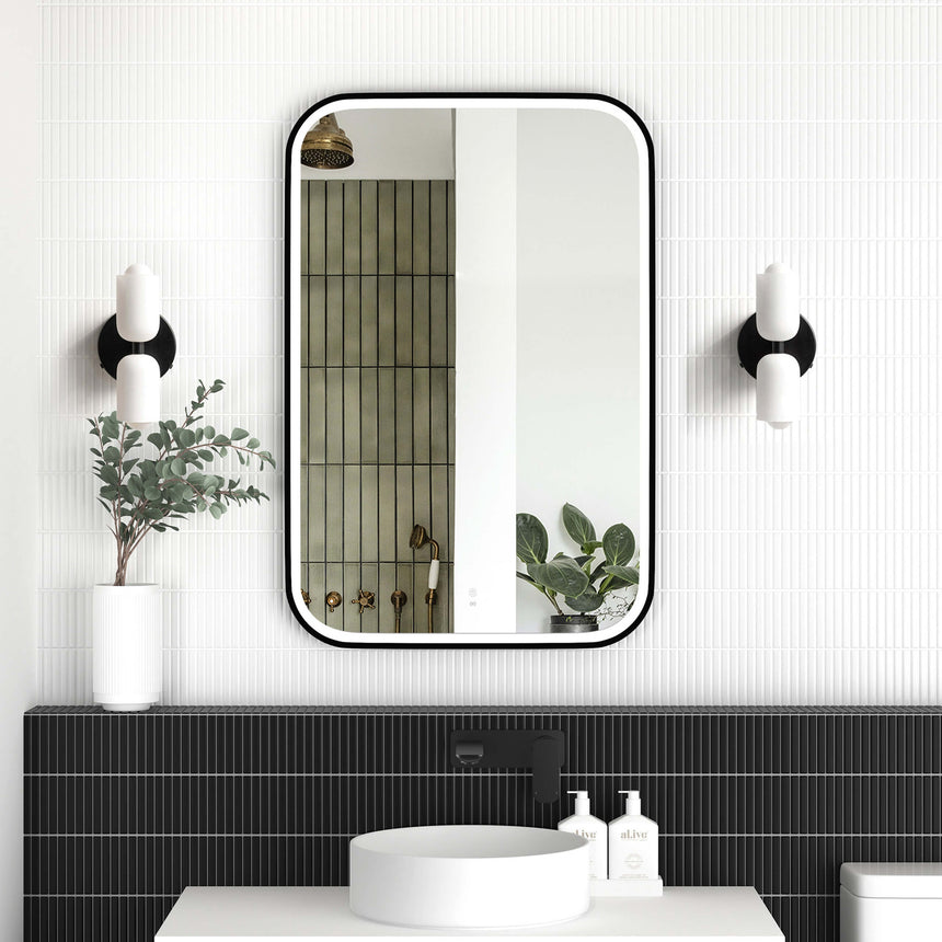 Otti Newport 900x600mm LED mirror by Tilemall with matte black frame and dual wall lights in bathroom interior