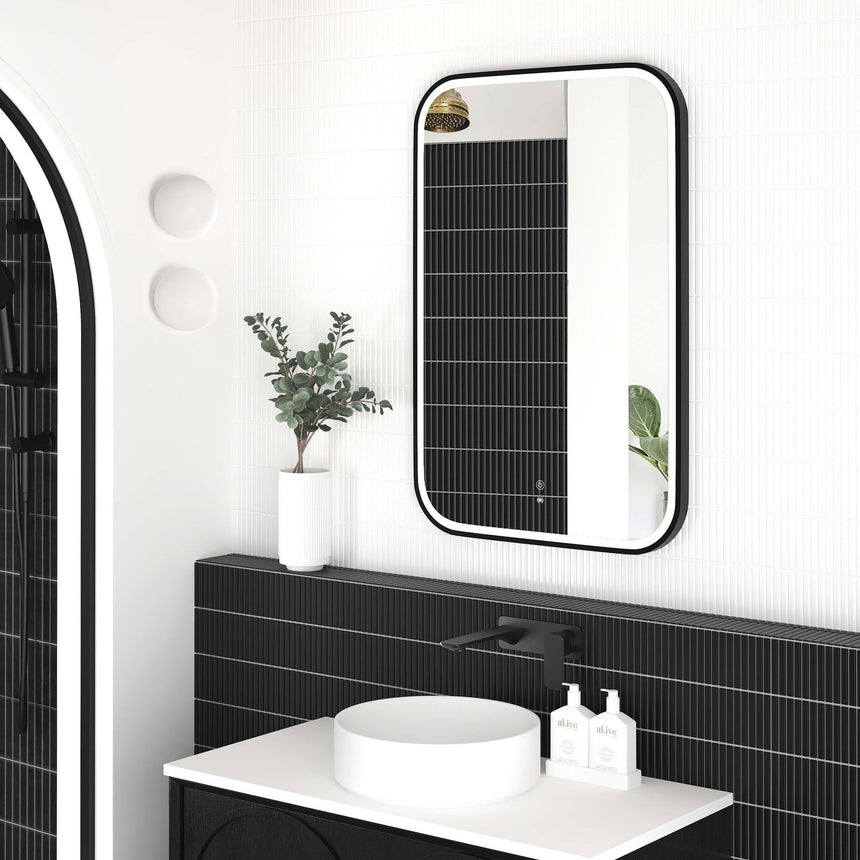 Otti Newport LED mirror 900x600mm matte black frame by Tilemall reflected in vanity setting with pendant lights