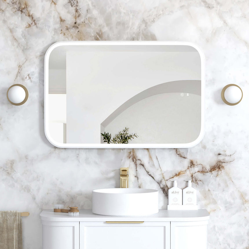 Otti Newport 900x600mm LED framed mirror by Tilemall in white with rounded corners, installed in bathroom interior