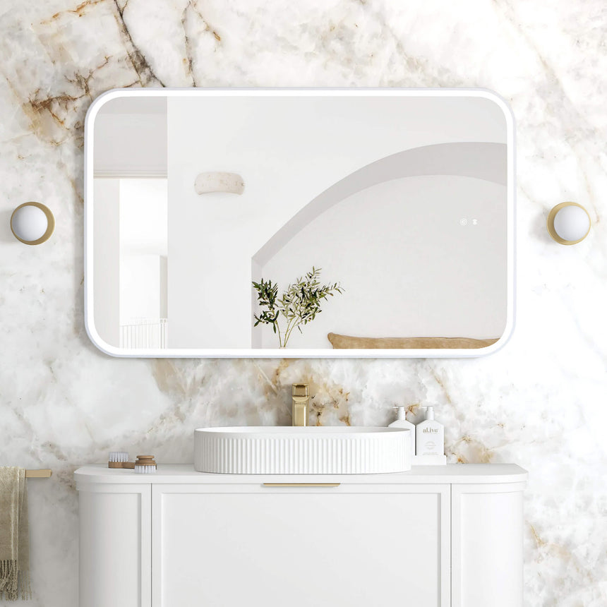 Otti Newport 1200x750mm LED framed mirror by Tilemall in white with rounded corners, installed above bathroom vanity