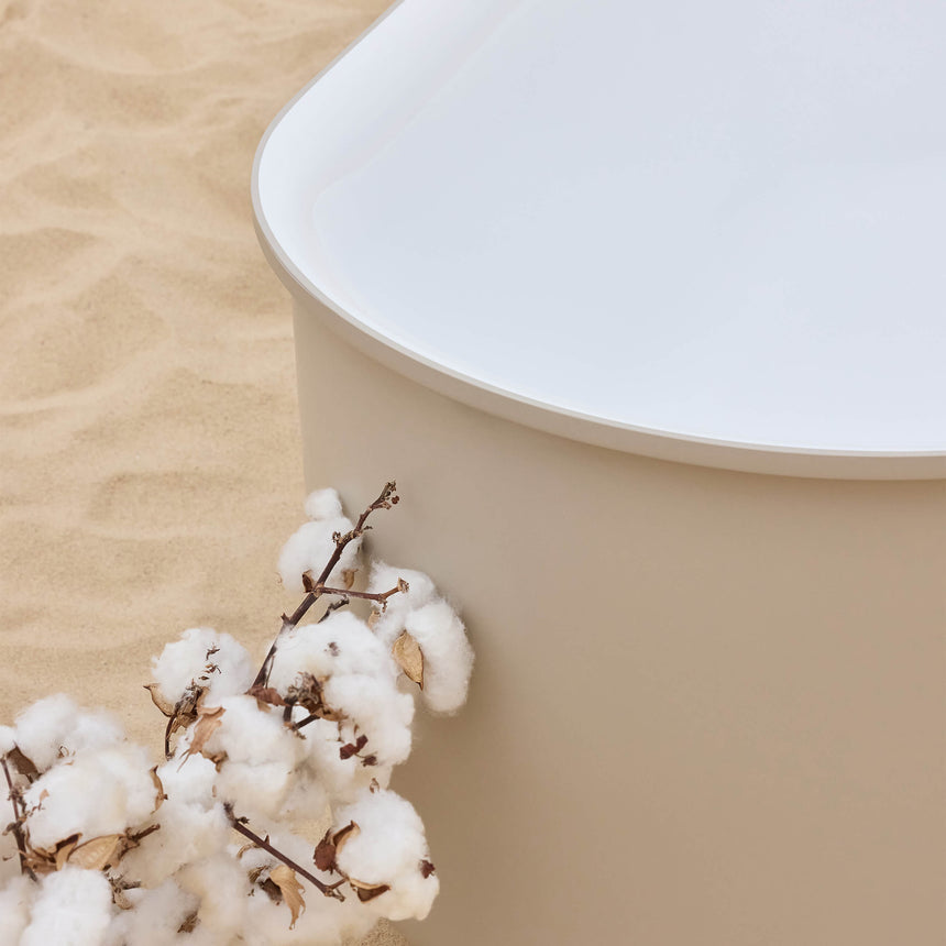 BelBagno Bath close-up of Berg bathtub rim and soft sand exterior with cotton flower detail on sand surface by Tilemall