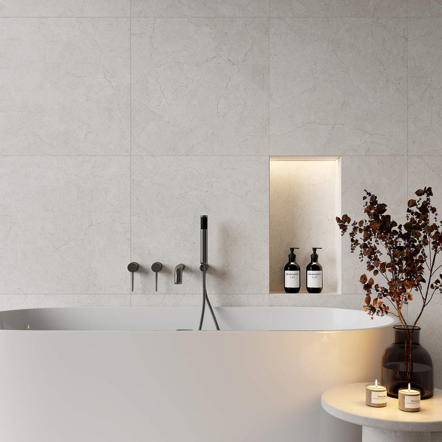 Crema Marfil 600x600mm matt bianco porcelain tiles installed as bathroom wall above soaking tub by Tilemall