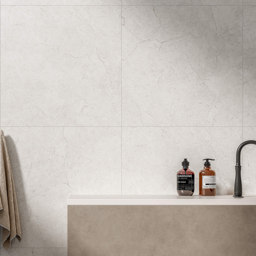 Crema Marfil 600x600mm matt bianco porcelain tiles installed as bathroom splashback above sink by Tilemall
