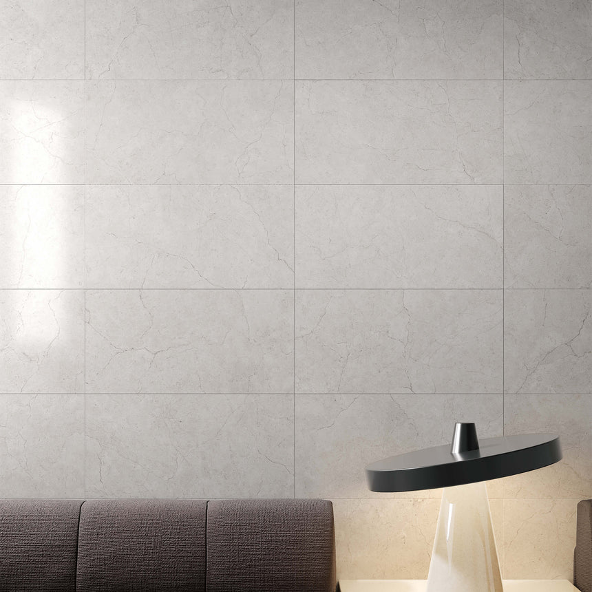 Crema Marfil bianco porcelain tiles installed as interior wall in 600x300mm format with soft grey crack-line veining by Tilemall