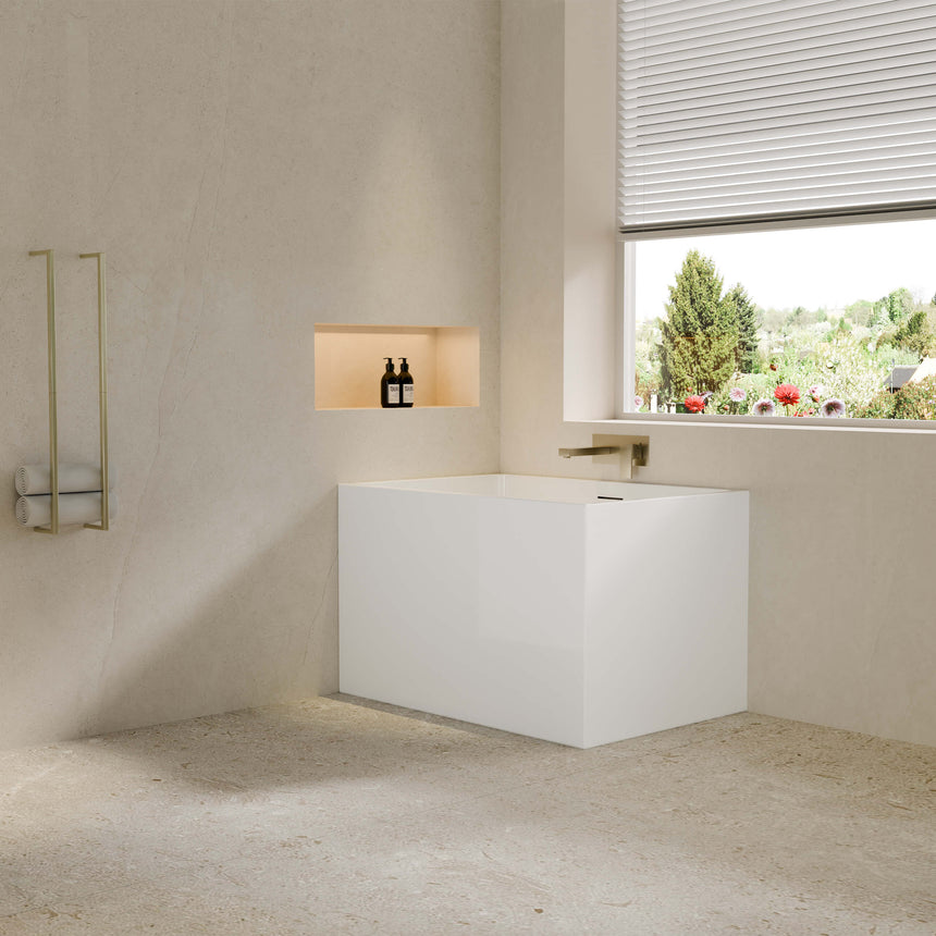 Lukka Back to Wall Bath 1000x680mm crete Multifit gloss white freestanding bathtub installed in modern bathroom interior by Tilemall