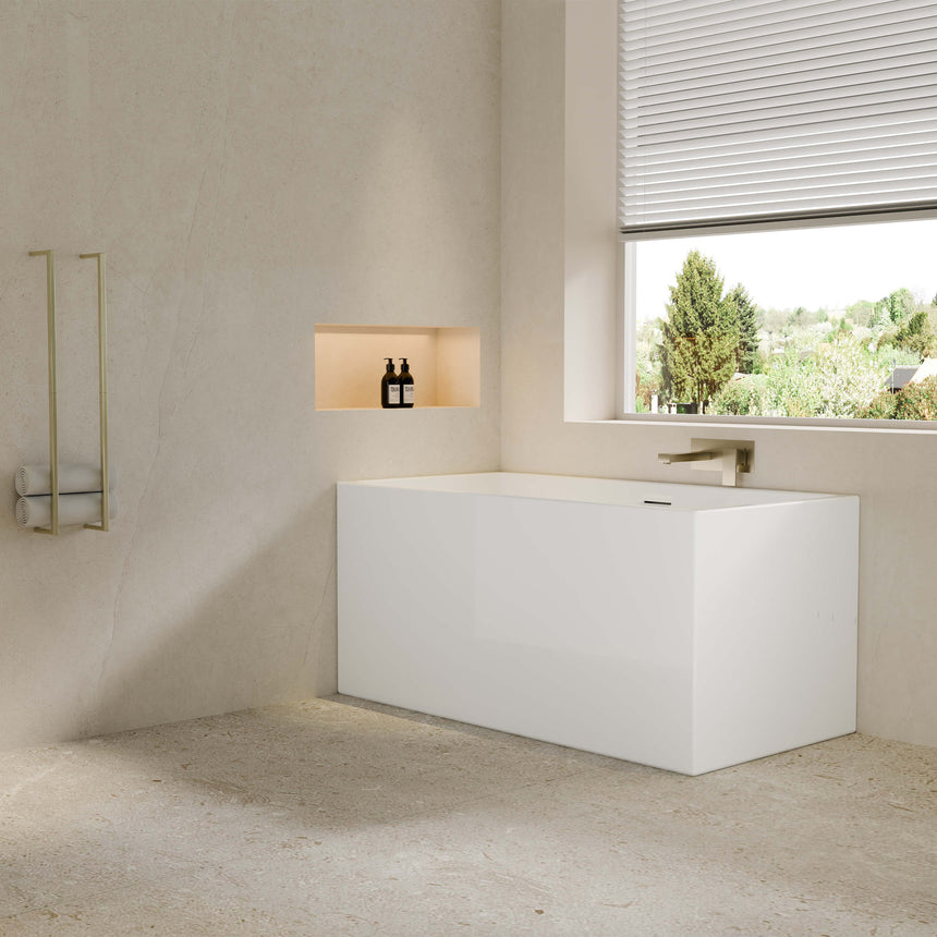 Crete 1300mm freestanding bathtub by Tilemall installed in modern bathroom interior with brass fixtures