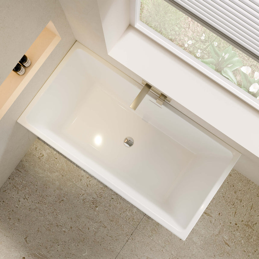 Overhead 1350x680mm view of Crete bathtub by Tilemall showing rectangular basin, overflow hole and brushed brass tapware