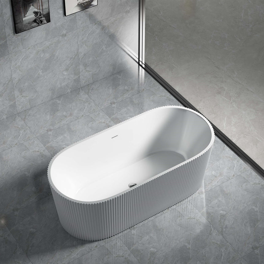 Agena 1700x805mm fluted bath installed in bathroom interior, side angle showing matte white finish and ribbed texture by Tilemall