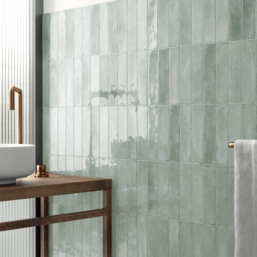 Acquarello 60x246mm fossil gloss subway tiles installed as bathroom wall splashback in vertical stack pattern by Tilemall