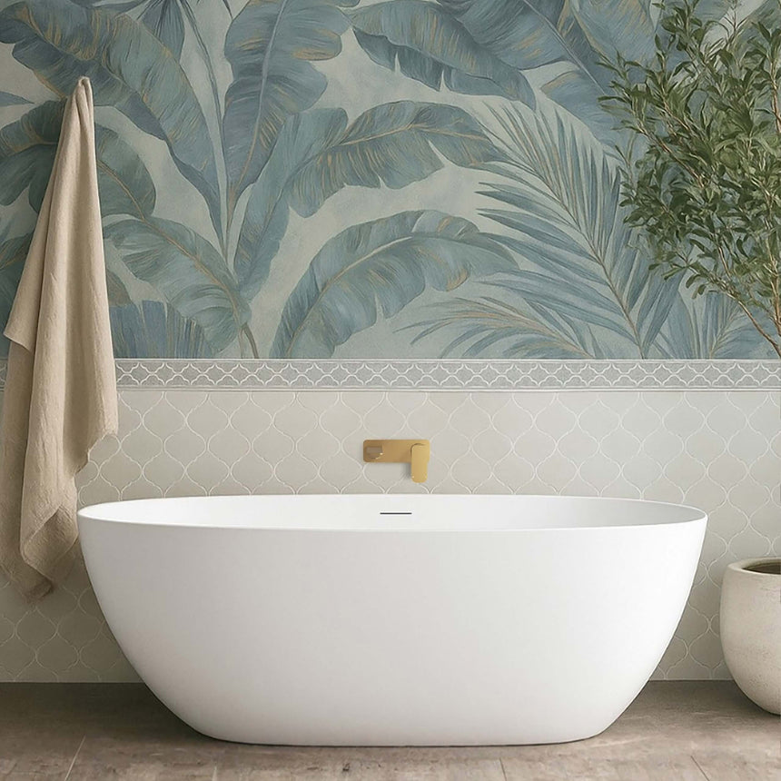 Otti Attica Manolo bathtub installed in bathroom interior with patterned tile wall and brass wall-mounted spout by Tilemall