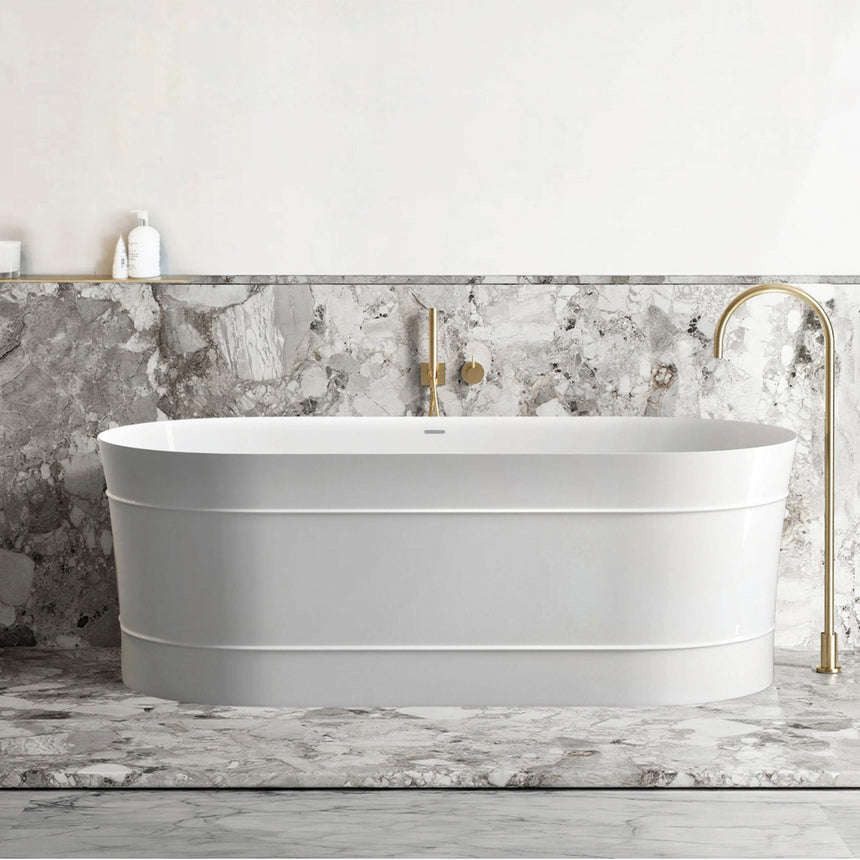 Otti Attica Bondi gloss white freestanding bathtub installed in bathroom interior with marble tile and brass tapware by Tilemall