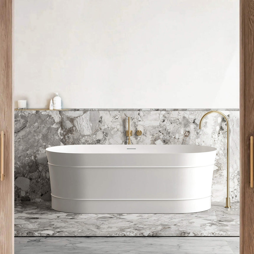 Otti Attica Bondi 1500mm matte white freestanding bathtub in bathroom interior with marble surround and brass fixtures by Tilemall