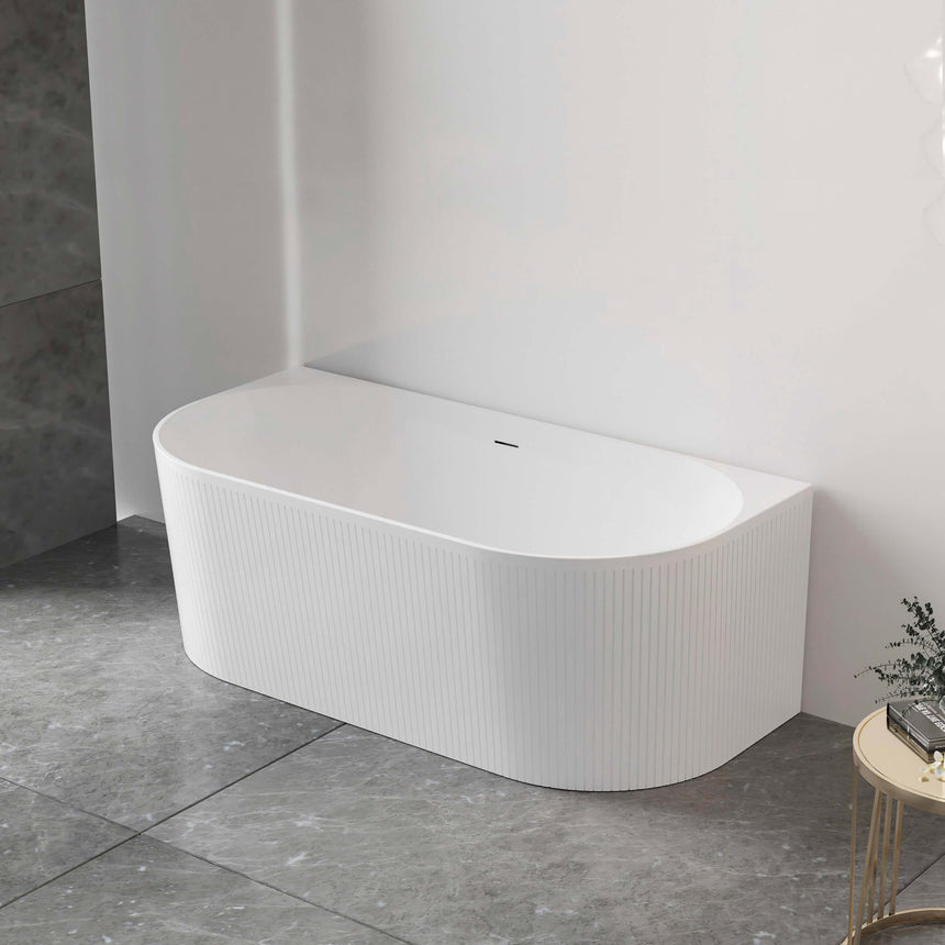 Otti Attica Noosa back-to-wall fluted bath installed in bathroom corner, matte white with rounded edges by Tilemall