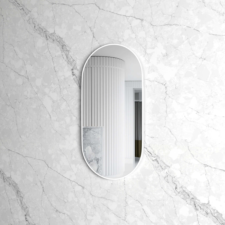 Otti Noosa oval framed mirror installed on marble wall in bathroom interior by Tilemall