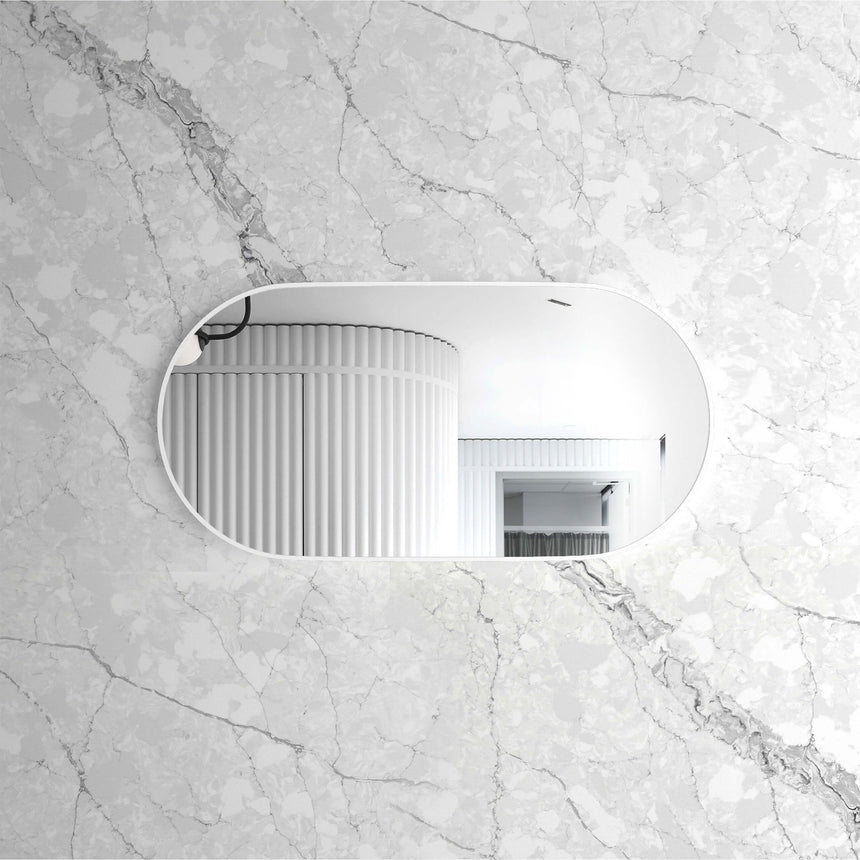 Noosa 1200x600mm oval framed mirror in white, horizontal orientation installed on marble wall by Tilemall