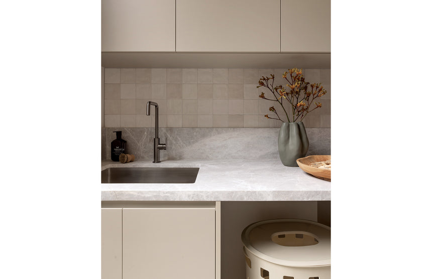 Phoenix Mekko brushed carbon sink mixer in kitchen with subway tile splashback and marble benchtop by Tilemall