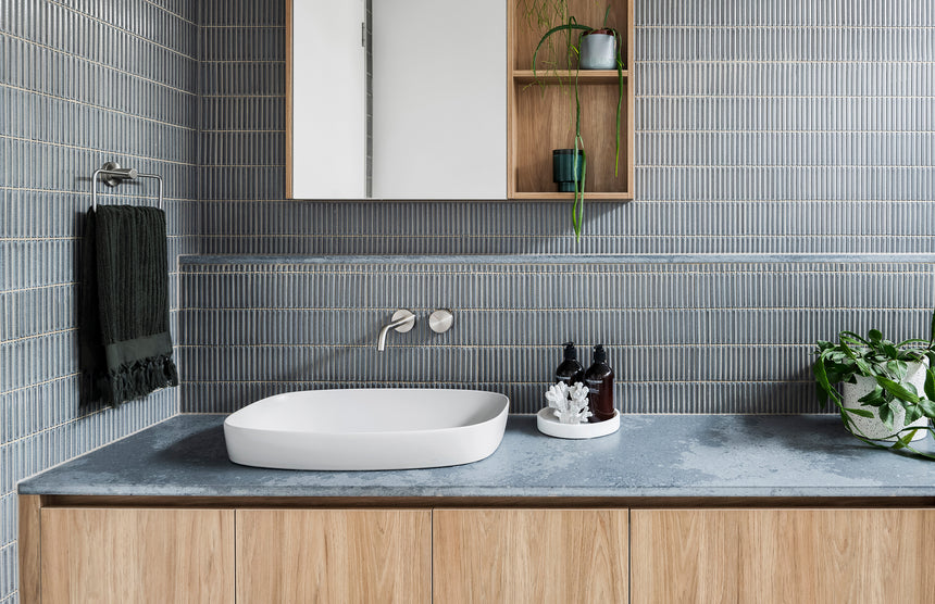 Phoenix Radii brushed nickel towel holder mounted on bathroom wall above sink by Tilemall