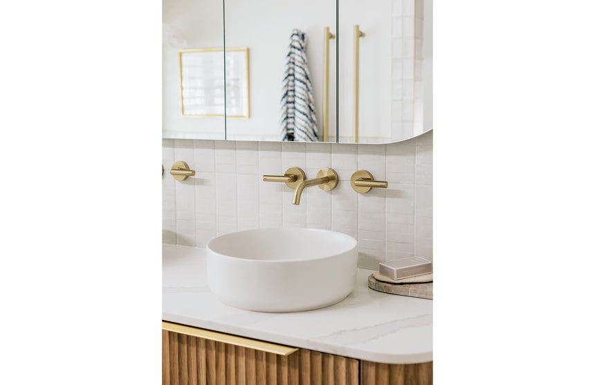 Phoenix Vivid Slimline Plus brushed gold three-hole wall mixer with spout and lever handles above round basin by Tilemall