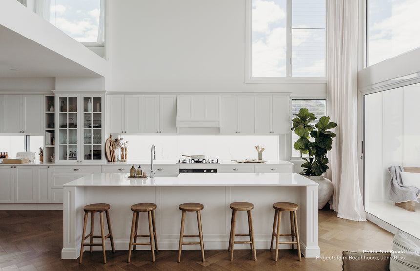 Phoenix Nostalgia chrome pull-out sink mixer in modern white kitchen with island seating by Tilemall