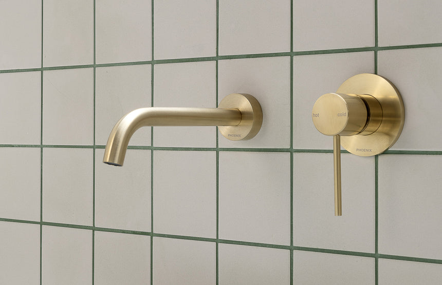 Phoenix Vivid Slimline brushed gold bath spout and wall mixer on tile wall by Tilemall