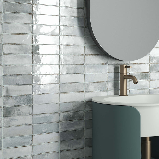 Piccolo 50x150mm gloss mist blue subway tiles installed as bathroom wall splashback by Tilemall