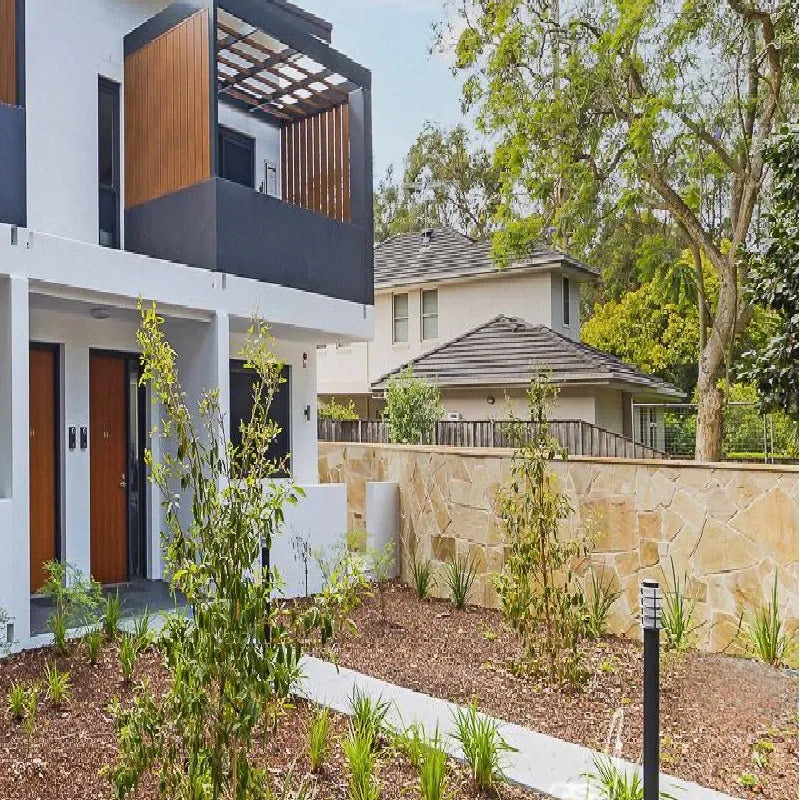 Sunrise Gold gold-toned irregular stone on garden walls outside a home by Tilemall