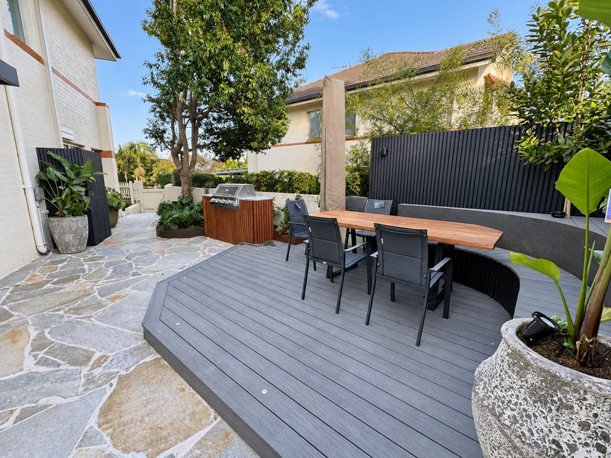 Mangolia crazy paving surrounding a raised timber deck by Tilemall