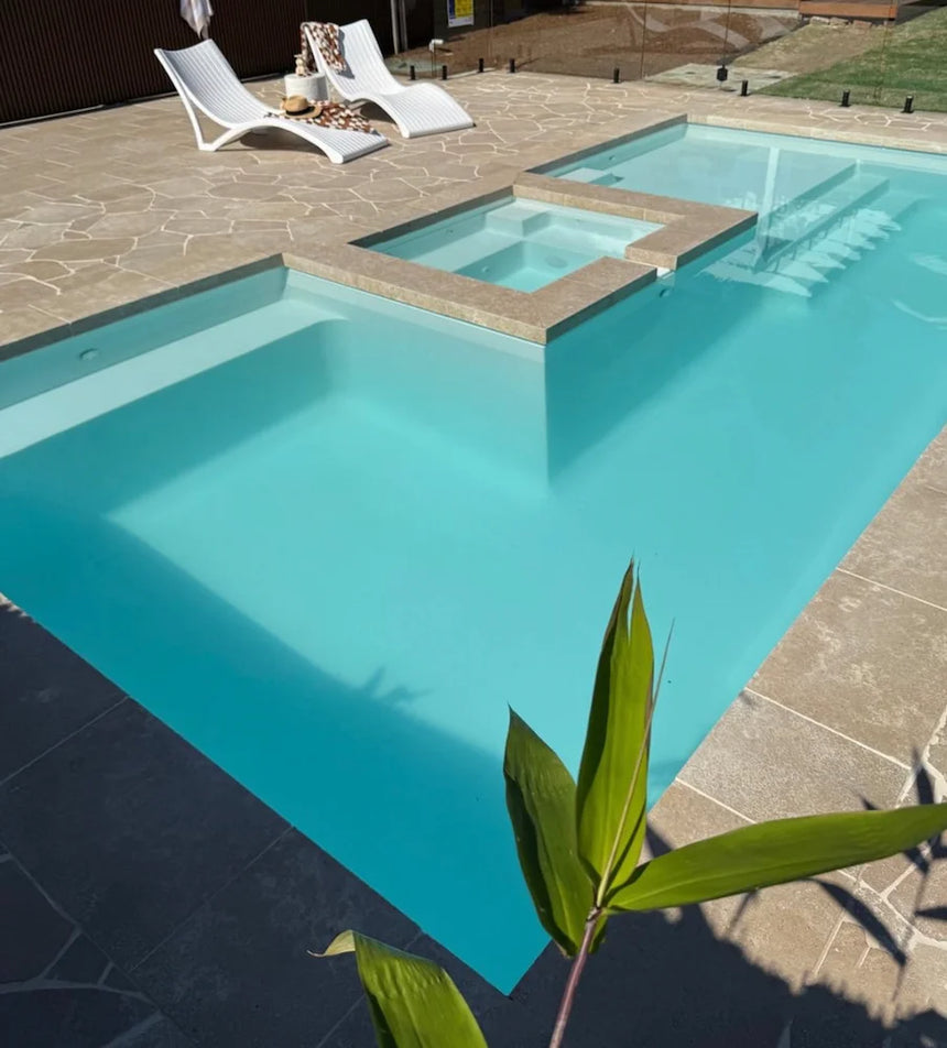 Avani Limestone crazy paving around a swimming pool by Tilemall