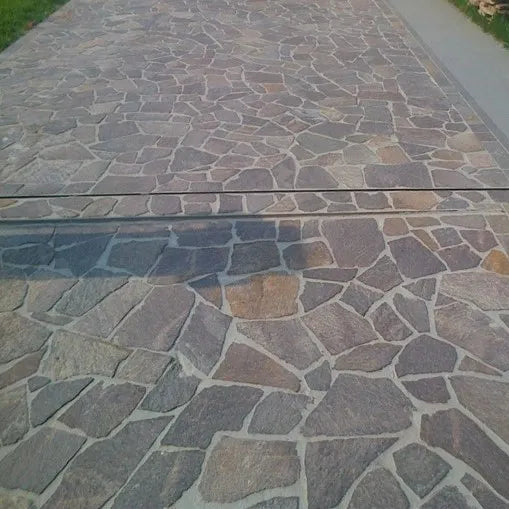 Porphyry crazy paving leading across an outdoor terrace by Tilemall