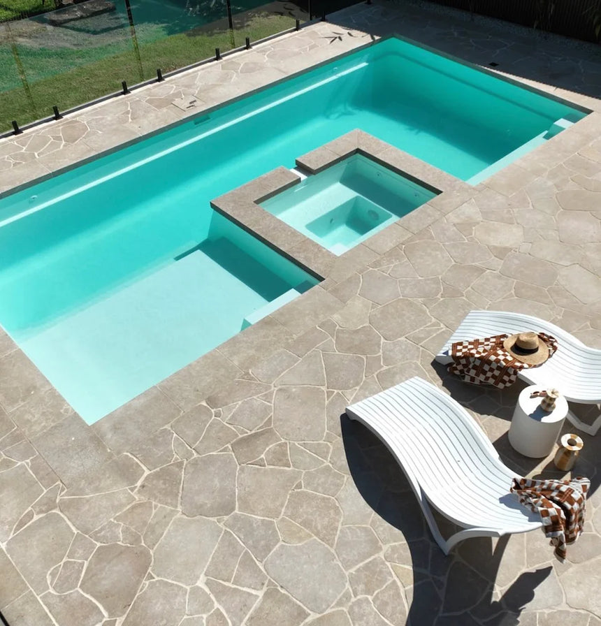 Avani Limestone overhead view of a paved swimming pool terrace by Tilemall
